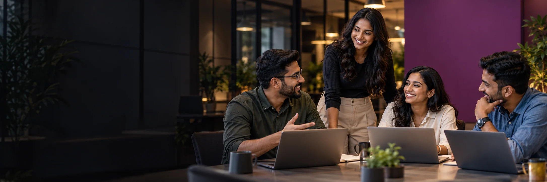 Colleagues laughing and working together in the Swati Tech team workspace